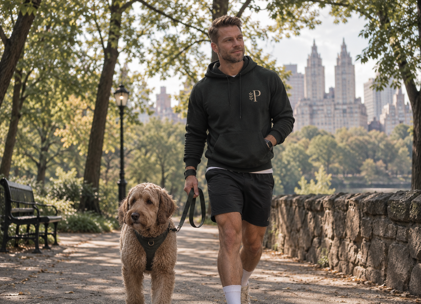 Brad walking a dog along a tree-lined Central Park path